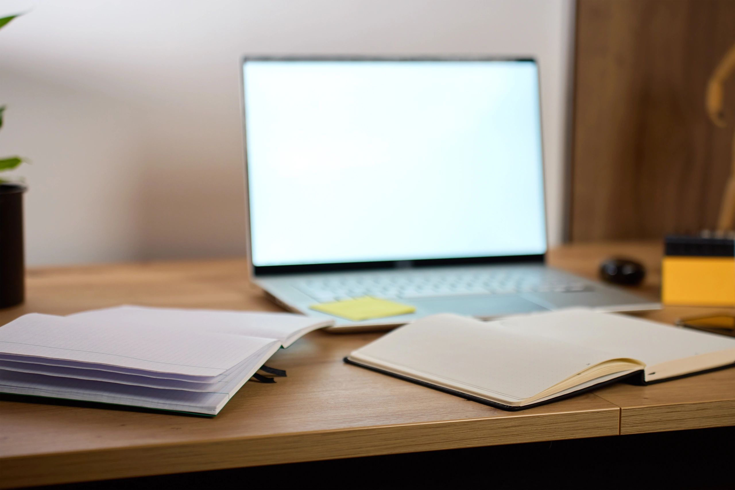 Editorial workspace with laptop and notebooks